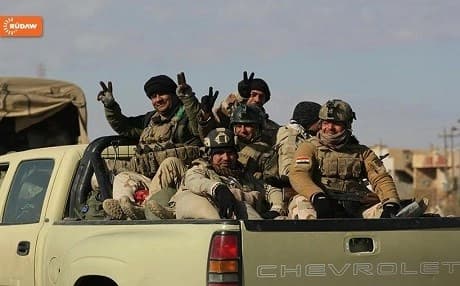 Iraqi soldiers celebrate after completing Phase 1 in efforts to liberate the city of Mosul from ISIS.
