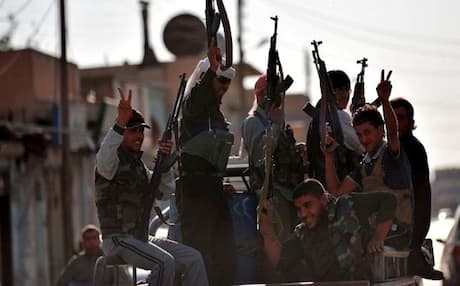 Syrian rebels make victory signs in the town of Tal Abyad near the border with Turkey. Photo: AFP