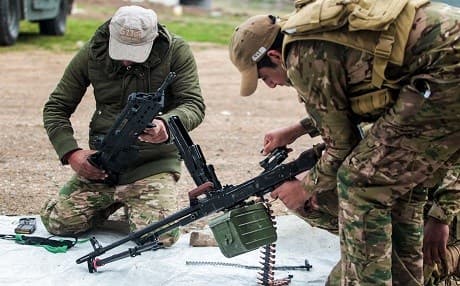 Iraqi forces clean their arms and prepare their combat gear south of Mosul in mid February. Photo: AFP / Ahmad Al-Rubaye