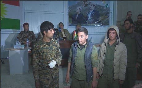 Four of the five fighters of the Shingal Protections Units (YBS) walk out of a hall where Peshmerga commanders hold a press conference on Saturday in Shingal.  They were released based on an order from President Masoud Barzani, a Peshmerga commander said. Photo:Rudaw video. 