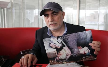 Turkish photographer Ramazan Ozturk shows his iconic photo at the 25th anniversary of the chemical gas attack in Halabja. Photo: Rudaw