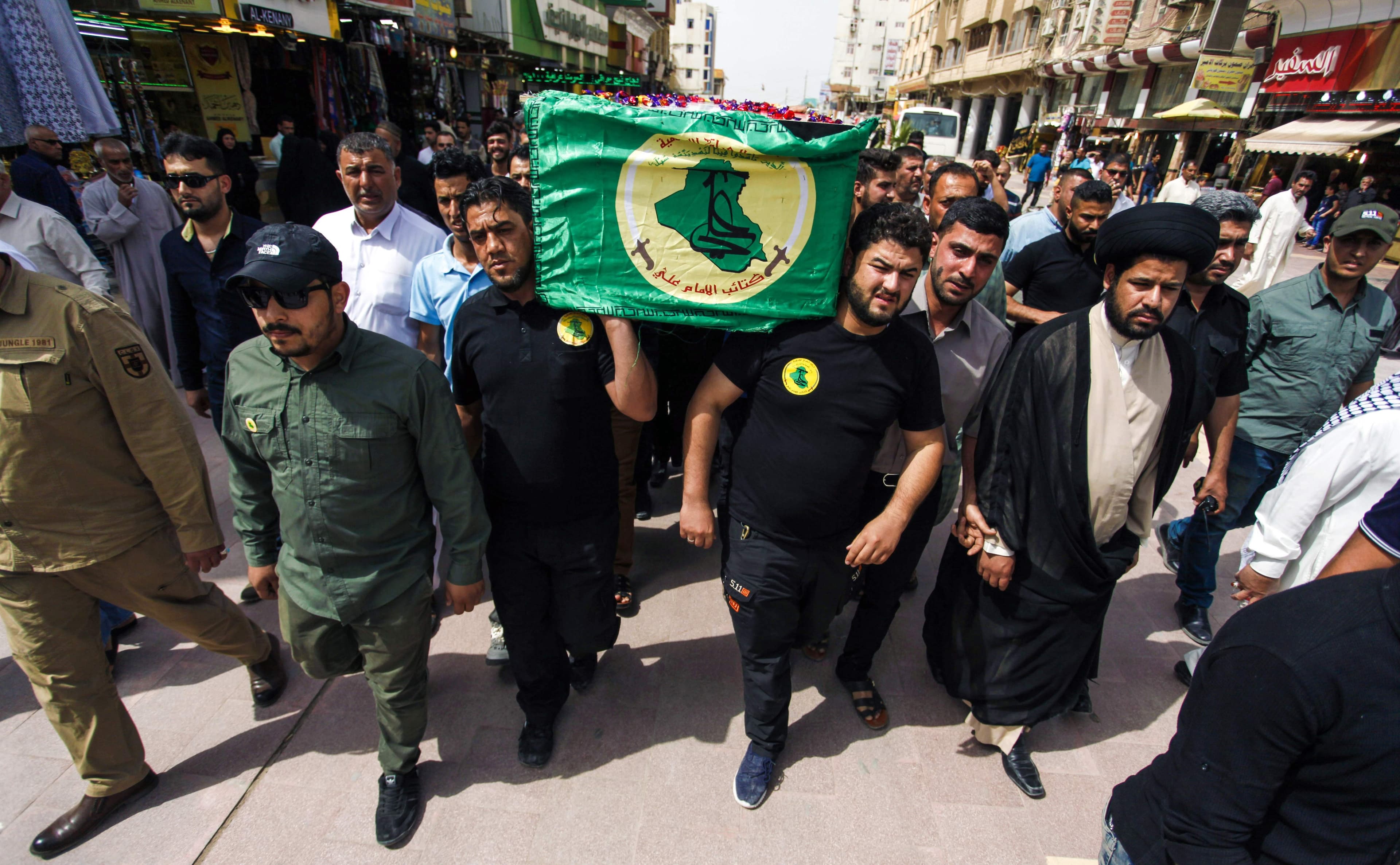 Iraqis carry the coffins of fallen members of the Hashed al-Shaabi (Popular Mobilisation) paramilitary forces, who support Iraqi forces in the battle against the Islamic State (IS) group, during a funeral on April 27, 2017, in the holy city of Najaf, after some were killed the day before in combat while fighting to retake the northern city of Mosul. Photo: AFP/Haidar Hamdani