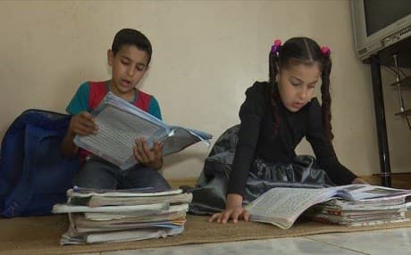 Mustafa Abdullah [L], a 5th-grader student displaced to the Kurdish city of Halabja study with his sister in a rented home. Their father, a teacher with Master's degree is on strike over unpaid salaries. Photo: Rudaw video