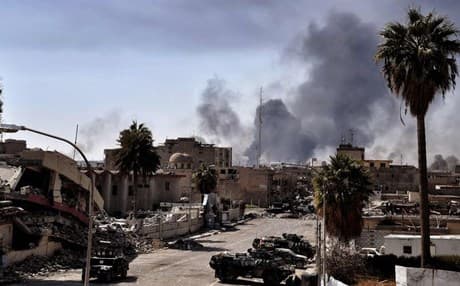 Smoke billows above Mosul as Iraqi forces have been fighting ISIS to recapture the city. Photo: AFP via Getty