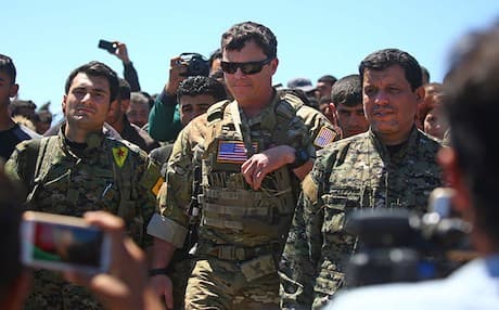 This AFP photo shows US officers from the US-led coalition when visiting fighters with the Kurdish People’s Protection Units (YPG) at the site of Turkish airstrikes near northeastern Syrian Kurdish town of Derik on April 25, 2017. 
