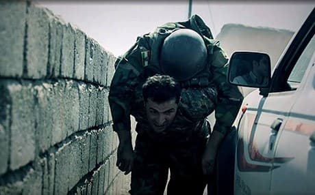Nahro Luqman, a Peshmerga fighter on the Gwer front, is trying to save his fellow Peshmerga injured in clashes with ISIS militants in August 2015. The injured Peshmerga, then named as Nabi Alyas, died of his injures. Photo: Rudaw/Farzin Hassan