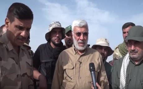 Mahdi Muhandis [M], the deputy head of the mainly Shiite Hashd al-Shaabi speaks to a reporter in the liberated village of Kocho, a Yezidi area that has become the face of the ISIS genocide against the Yezidis . Photo: Hashd media office 