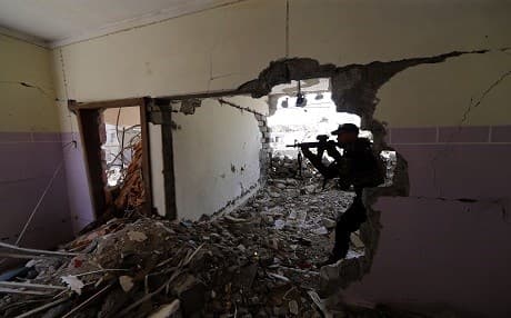  A member of the Iraqi forces guards a position in Mosul's western al-Saha district, north of the ISIS-held Old Mosul, during their ongoing battle to retake the area from the ISIS group militants on May 28, 2017. Photo: AFP / Karim Sahib