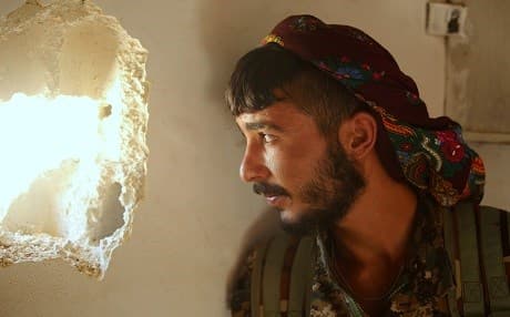 A member of the Syrian Democratic Forces (SDF), made up of an alliance of Kurdish and Arab fighters, guards a position in the al-Meshleb district of Raqa city, the de facto capital of the ISIS group on JUne 7, 2017. The SDF launched an offensive to drive out the extrimist group from Raqqa earlier this week. Photo: AFP/Delil Souleiman