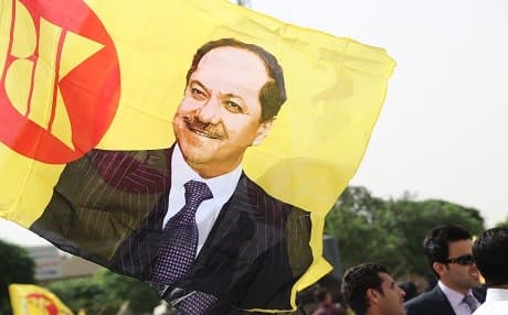 President Masoud Barzani's supporters fly high a flag of the Kurdistan Democratic Party with his portrait. File photo: Rudaw 