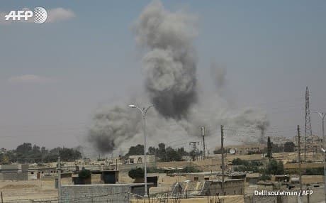Smoke rises over Raqqa on Sunday. Photo: Delil Souleiman/AFP
