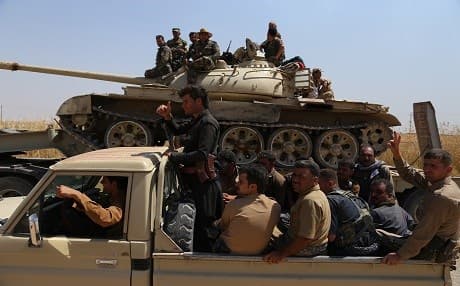 Regular Peshmerga forces and Kurdish volunteers heading to a frontline south of Kirkuk to defend the area against ISIS takeover, 2014. Photo by Farzin Hassan/Rudaw