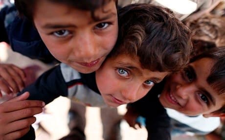 Displaced Iraqi children, who fled the ongoing Mosul offesnive, pose for the camera at the Hasan Sham camp , 30 kilometres east of the city. Photo: AFP/Ahmad Gharabli