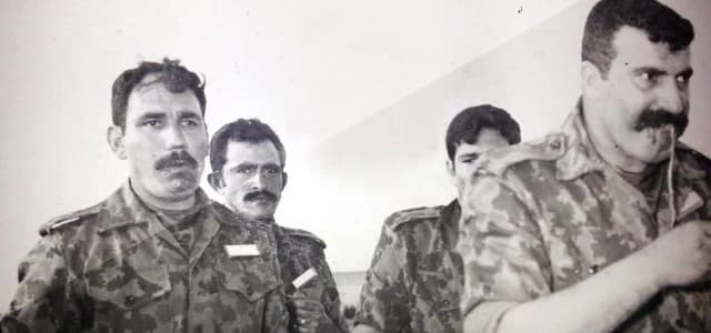 A man named as Hajaj Tikriti [R], said to be in charge of the death camp of Kurds in Nugra Salman, southern Iraq, in this photo obtained by Rudaw appears to be engaged with military training with some other people who also appear to have blood on their face, possibly snake blood.