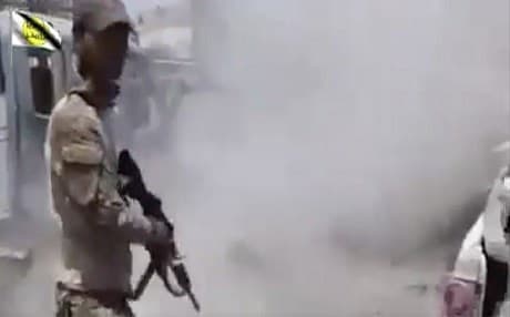 This file photo made from undated video posted online in July shows a man in an Iraqi army uniform moments after shooting an unarmed man in Mosul, Iraq. Photo: AP