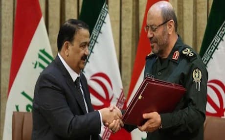 Iranian Defense Minister Brig. Gen. Hossein Dehqan [R] shakes hands with his Iraqi counterpart Maj. Gen. Erfan al-Hiyali after signing a memorandum of understanding on joint military cooperation. Photo: IRNA