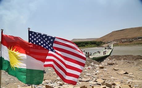 The flags of the Kurdistan Region and the United States fly high in a border crossing between the Kurdistan Region and Syria in the Summer of 2014 after the arrival of some Yezidi survivors who escaped the ISIS attacks against their communities in and around Shingal. US first carried out airstrikes against the ISIS group after the August, 2014 Yezidi genocide in support of the Peshmerga forces. File photo: Rudaw