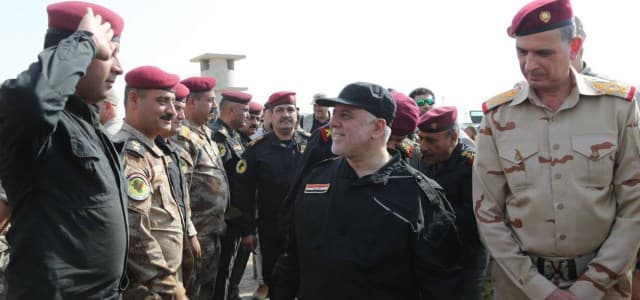 File photo shows the Iraqi Prime Minister Haider al-Abadi greeted by Iraqi commanders and security forces in Mosul on July 9, 2017, a day before he declared victory over ISIS in the city. Photo: Iraqi PM media office 