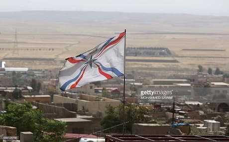 An Assyrian flag flutters over the town of Al Qosh north of Mosul. Photo: Mohammed Sawaf | AFP