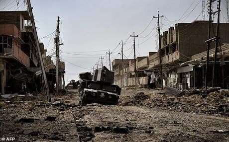  AFP file photo of an Iraqi armored vehicle driving through a heavily damaged street in west Mosul.