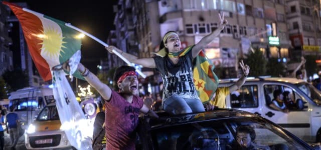 Supporters of pro-Kurdish Peoples' Democratic Party (HDP) hold Kurdish flags as they celebrate the results of the legislative election, in Diyarbakir on June 7, 2015 that saw the party enter the Turkish parliament for the first time. File photo: AFP/Bulent Kilic
