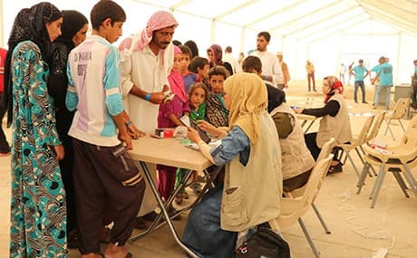 A family completes paperwork at the newly opened Nimrud camp near Tal Afar. Photo: UN
