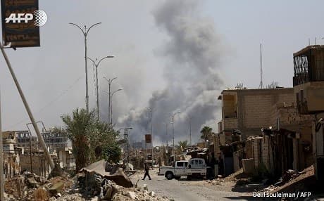 Smoke billows over Raqqa on September 4, 2017. Photo: Delil Souleiman/AFP