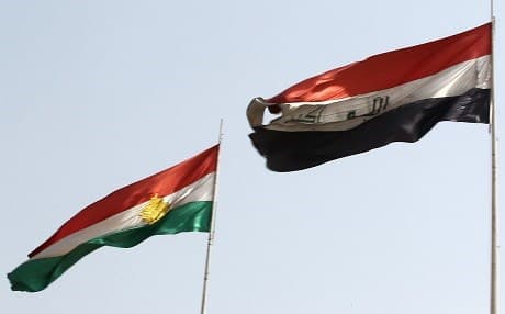 The flags of Kurdistan and Iraq fly next to eachother in oil-rich Kirkuk on September 26. Photo: Ahmad al-Rubaye | AFP