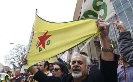 A man with a flag of the Syrian Kurdish People's Protection Units (YPG). File photo: AP/ Serkan Gurbuz