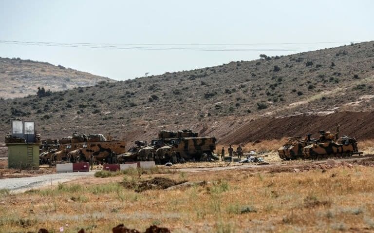 Turkish armoured vehicles and soldiers at the Syria-Turkey border at Reyhanli district in Hatay, Turkey on Sunday. Photo: Ilyas Akengin/AFP