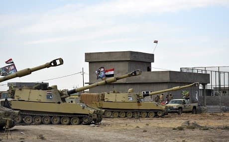 Iraqi army vehicles are seen parked near a former Kurdish military position on October 13, 2017 in Tuz Khurmatu, near the oil-rich province of Kirkuk. Photo: AFP/ Marwan Ibrahim 