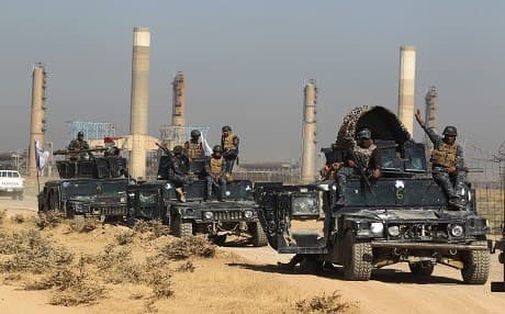  Iraqi forces drive through an oil field as they head towards the city of Kirkuk on October 16, 2017. Photo: AFP/Ahmad al-Rubaye
