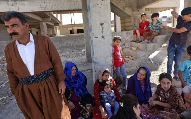 A Kurdish family sheltering at a construction site in Erbil after fleeing violence in the disputed areas near Kirkuk. Photo: Safin Hamed/AFP