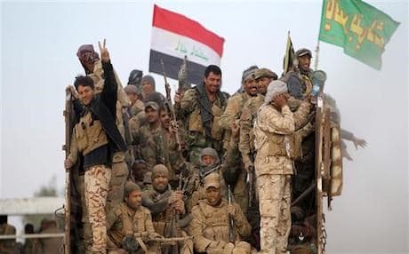 Iran backed Hashd al-Shaabi militias from the back of a truck as they drive towards a village in southwest of Mosul in October 2016. AFP photo