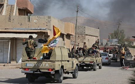Iraqi security forces and Iran-backed Hashd al-Shaabi militias patrol in Tuz Khurmatu that was evacuated by Kurdish security forces, Oct. 16, 2017. AP photo