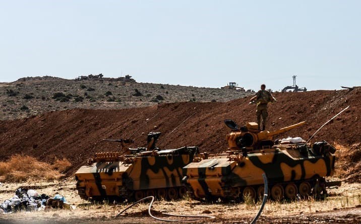 A Turkish soldier stands on an armoured vehicle on Turkey’s border with Syria’s Idlib in October. Photo: Ilyas Akengin/AFP