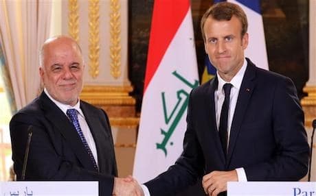 French President Emmanuel Macron (R) shakes hands with Iraqi Prime Minister Haider al-Abadi at the Elysee palace in Paris, on October 5, 2017. AFP file photo