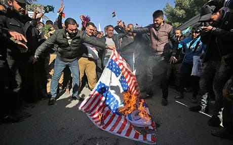 Supporters of Muqtada al-Sadr set US and Israeli flags on fire during a protest in Baghdad on Friday against Trump’s decision to recognize Jerusalem as the capital of Israel. Photo: Ahmad al-Rubaye/AFP