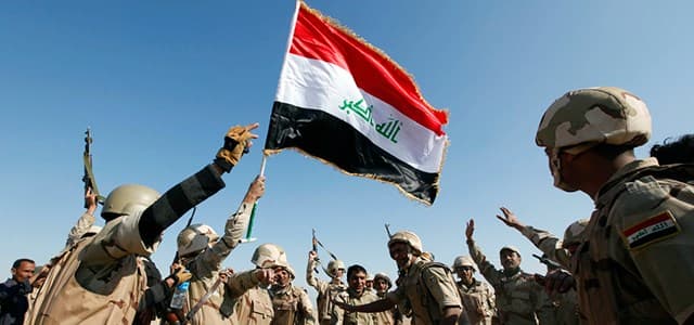 Iraqi Army soldiers celebrate after a victory over ISIS. Photo: AP