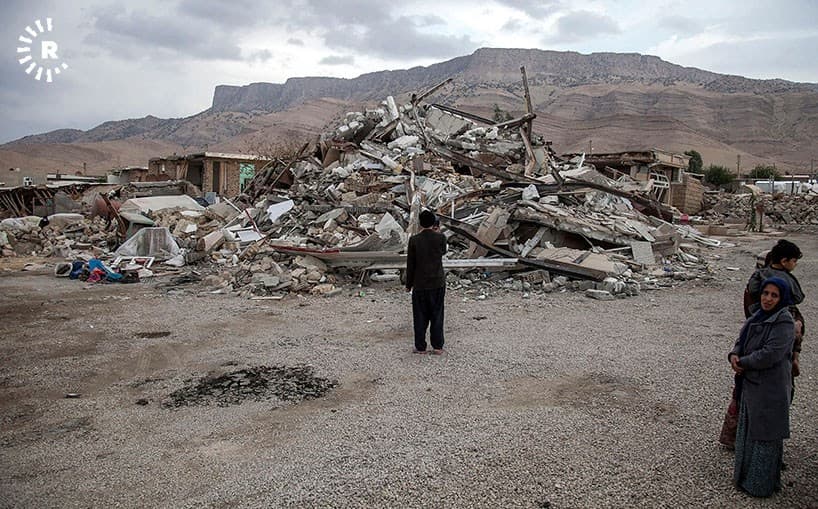 People look at the rubble of homes destroyed in the November 12 earthquake. Photo: Bahman Shabazi/Rudaw