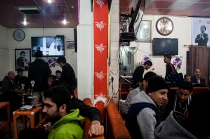 Young men enjoy tea and conversation at a cafe in Erbil’s busy Iskan Street. Photo by Kira Walker