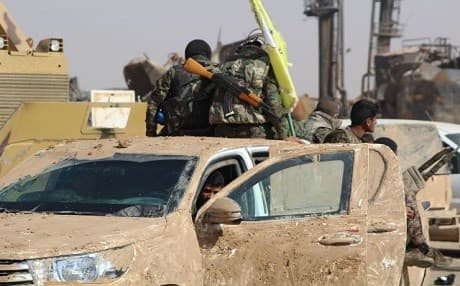Members of the Syrian Democratic Forces load onto a truck in northern Syria. Photo: SDF Press