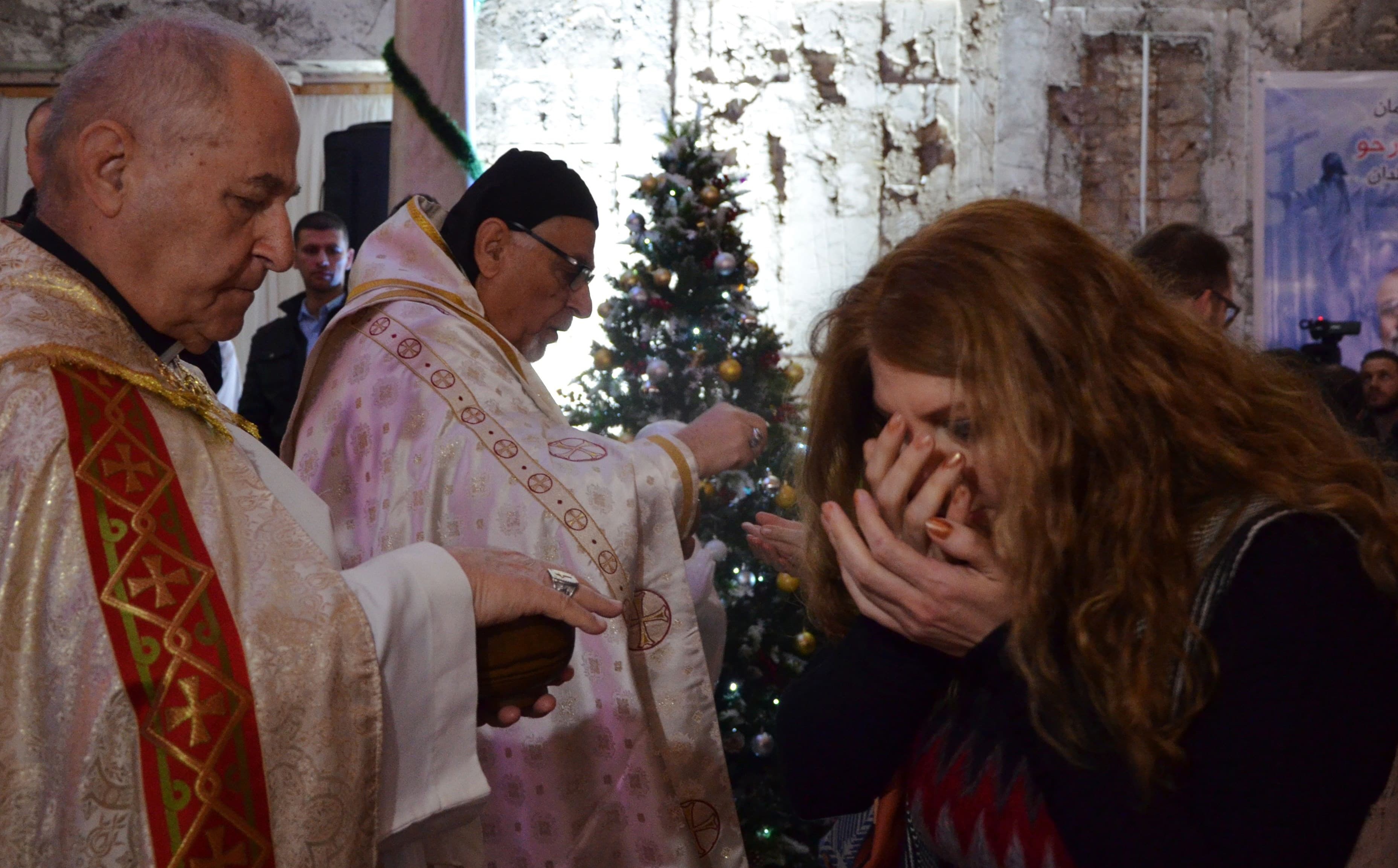 An Iraqi woman receives the Eucharist during Christmas mass at Saint Paul’s church in Mosul. Photo: Ahmad Muwafaq/AFP