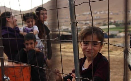 A young Yezidi girl stands near her family and the tent where they live on Mount Shingal. File photo: Hannah Lynch/Rudaw