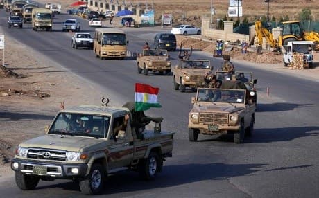 Kurdish peshmerga fighters drive in convoy through Erbil after leaving a base in Kurdistan on October 28, 2014 on their way to Kobane, a city in Syrian Kurdistan. File photo: AFP/Safin Hamed