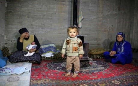 Families take shelter in basements in the Kurdish town of Jindaris near the Syrian-Turkish border, west of the city of Afrin on January 26, 2018. Photo: AFP / Stringer