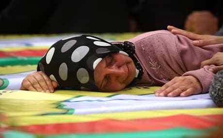 Syrian Kurds mourn in the northern town of Afrin during the funeral on February 1, 2018 of fighters from the People's Protection Units (YPG) and the Women's Protection Units (YPJ), killed in clashes in the Kurdish enclave in northern Syria on the border with Turkey. Photo: AFP/Delil Souleiman