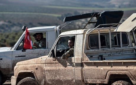 Turkish-backed Syrian rebel fighters drive toward the Turkish-Syrian border in Kilis, near ton January 30, 2018, as part ot the operation "Olive Branch" against Kurdish fighters in Syria. File photo:AFP/ Ozan Kose