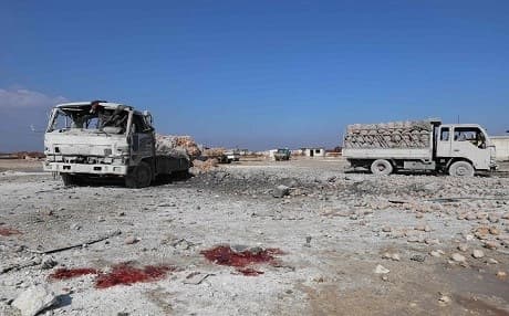 A picture taken on January 29, 2018 shows blood stains next to trucks loaded potatoes standing abandoned following airstrikes by government-aligned forces in the town of Saraqeb, Syria. Photo: Omar Haj Kadour