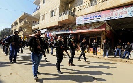 Kurds attend an impromptu parade in Afrin as civilians enlist to fight an assault by Turkish troops and allied rebels in the Syria-Turkey border region on January 28, 2018. Photo: Delil Souleiman | AFP